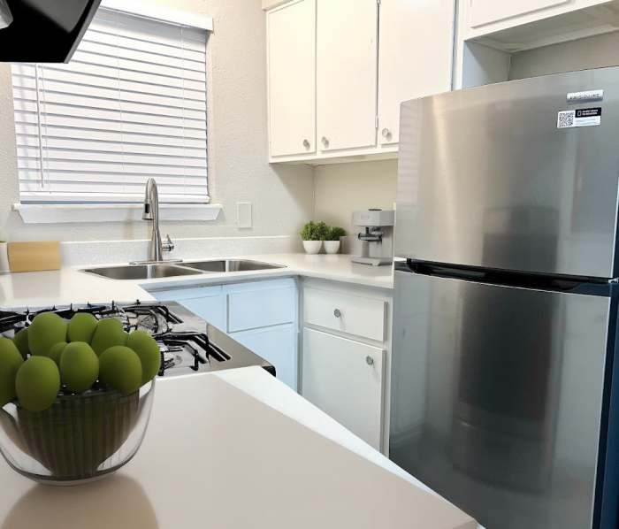 Kitchen with white cabinet at The Court at Oak Forest in Houston, Texas