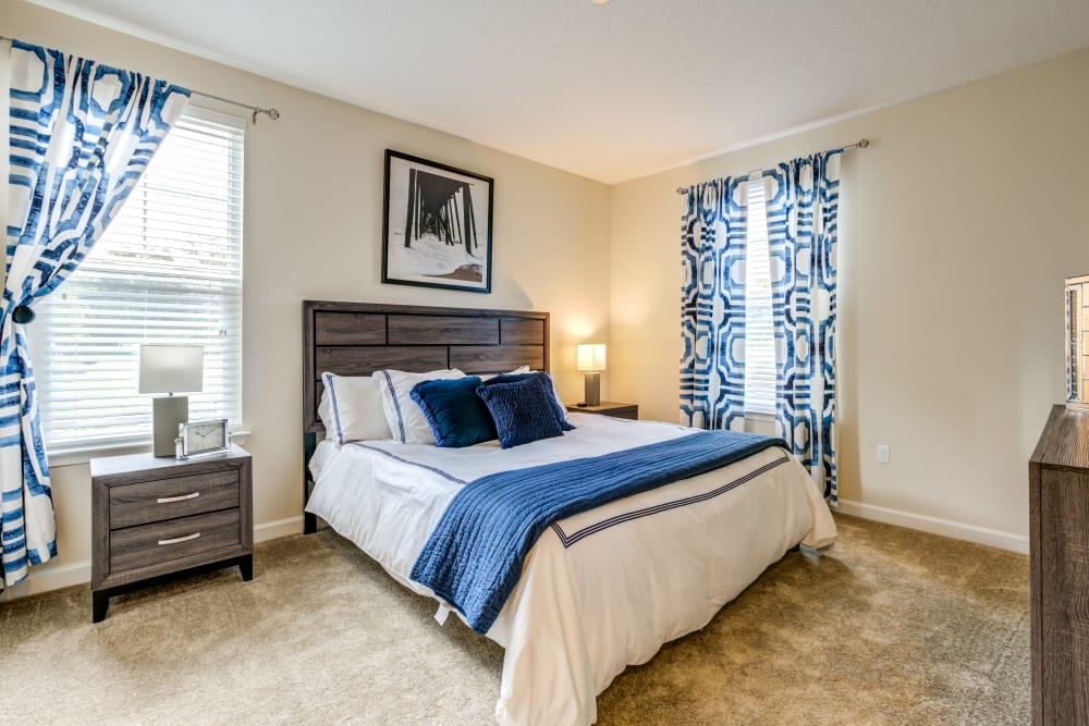 Comfortable model bedroom with plush carpeting at The Loop at 2800 in Sarasota, Florida