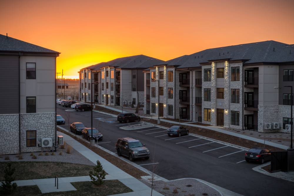 Apartment buildings at sunset with on-site parking at The Reserves at Eagle Point.