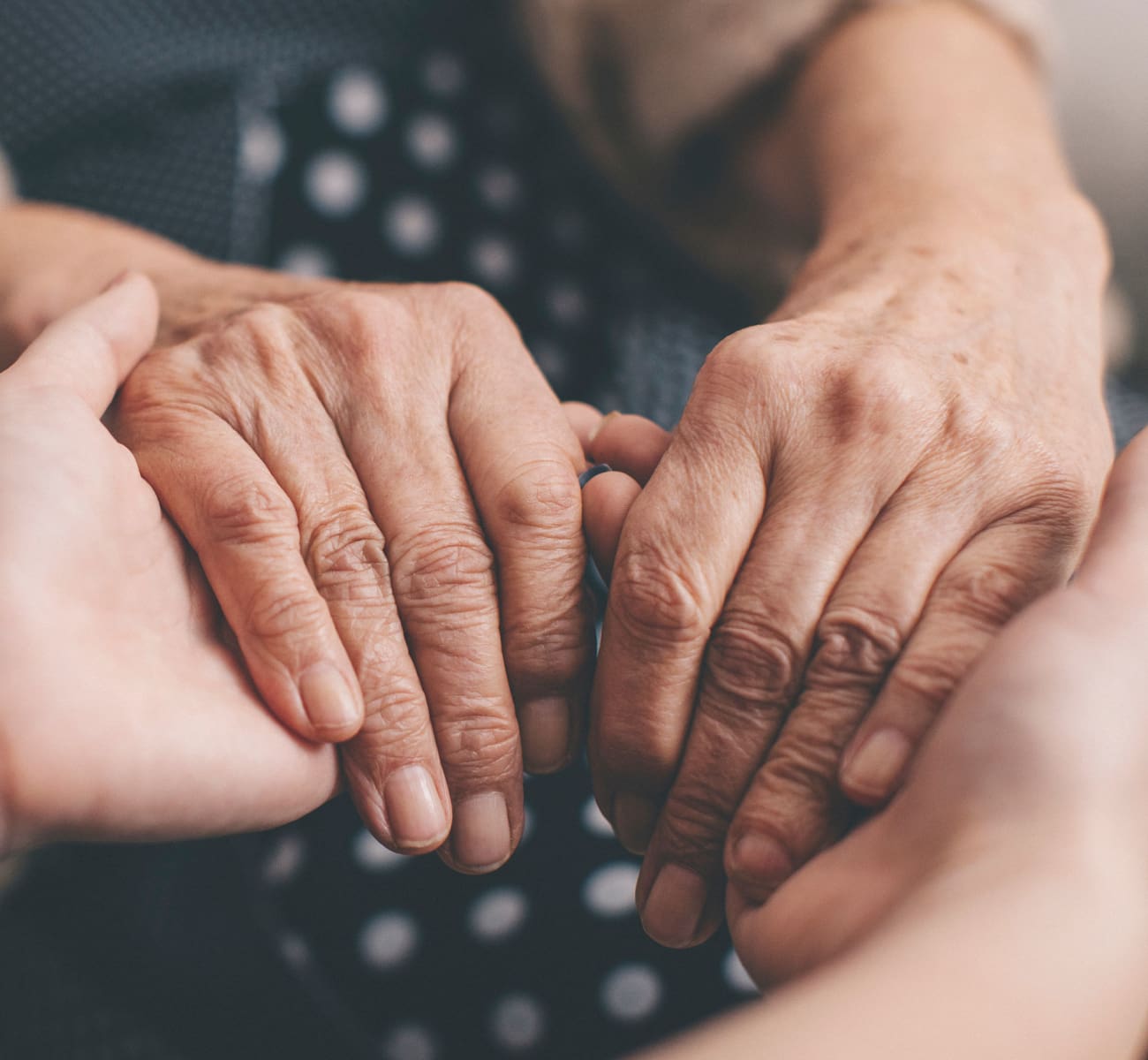 A caretaker holding a resident's hands at Sandpiper Courtyard in Mt. Pleasant, South Carolina
