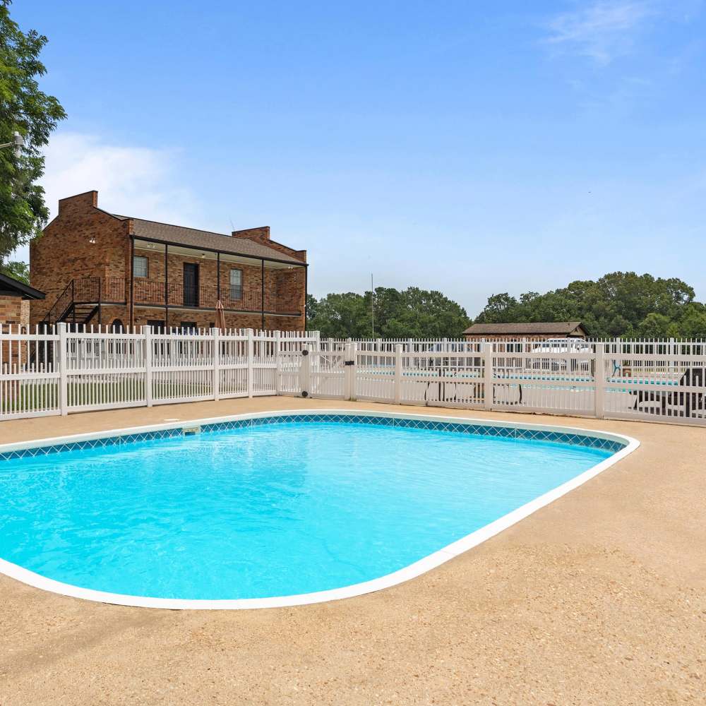 Sparkling water pool surrounded by a charming fenced area at Pecan Ridge in Vicksburg, Mississippi.