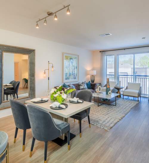 Furnished dining and living room of a model apartment unit at The Reverie at Lake Boone in Raleigh, North Carolina