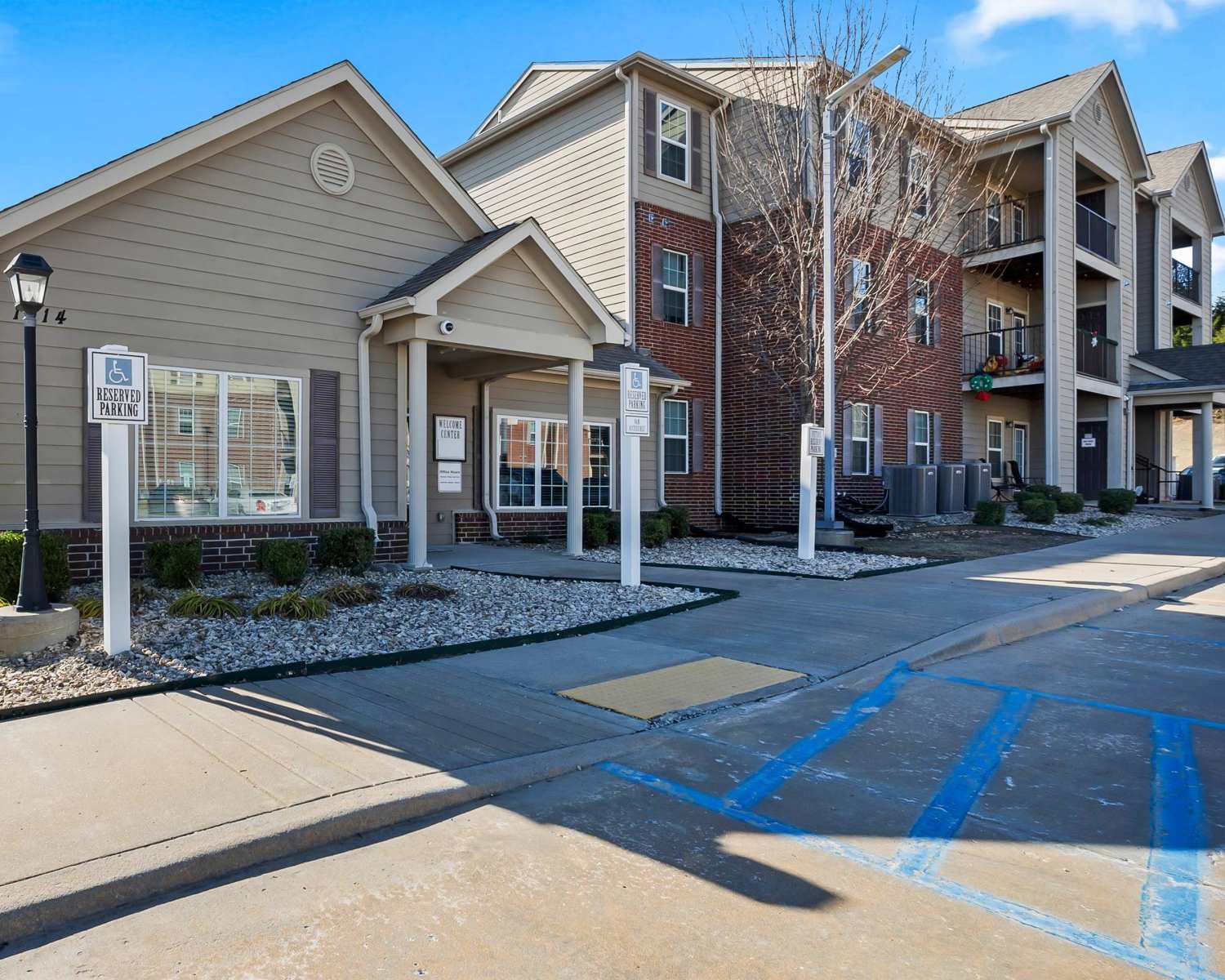 Elegant apartment complex entrance with reserved parking signage at Wickham Gardens in Sapulpa, Oklahoma 