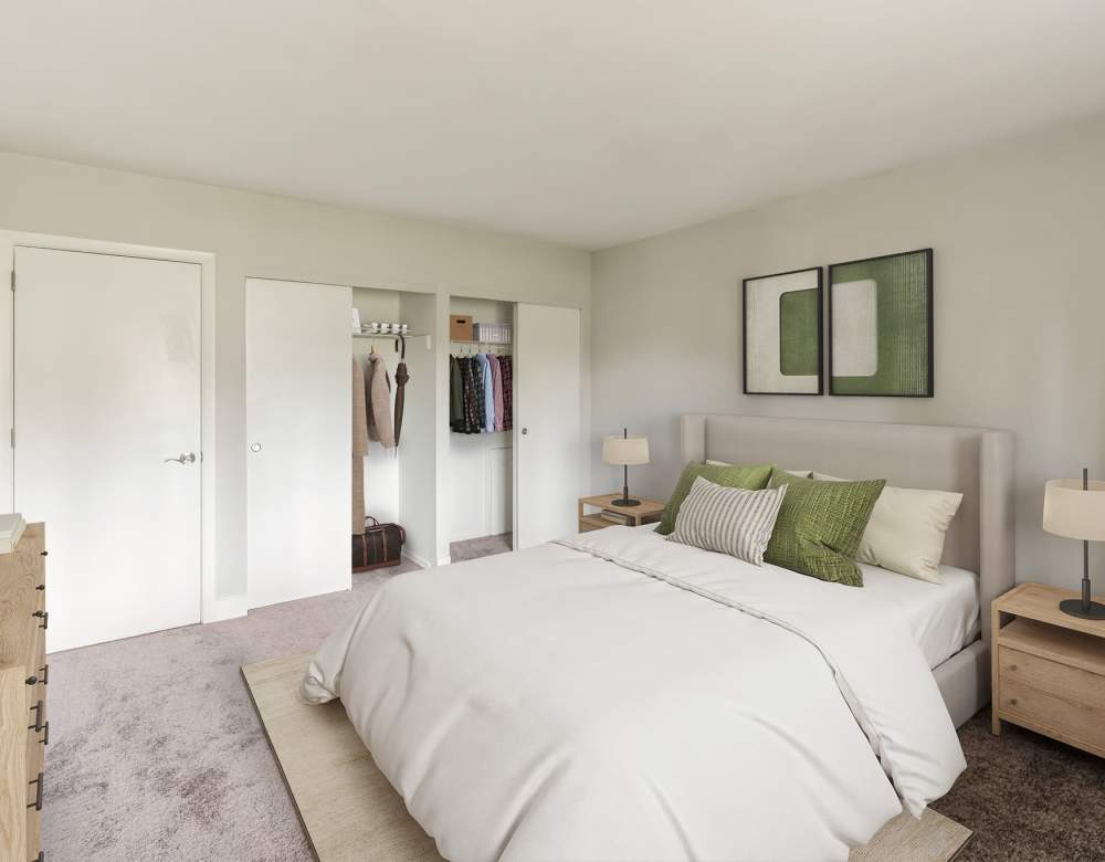 Naturally Well Lit Bedroom Area with green accent pillows and paintings at Eagle Rock Apartments at Malvern in Malvern, Pennsylvania