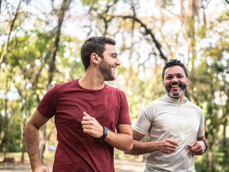 Two men running through a park near Gates at Jubilee in Daphne, Alabama