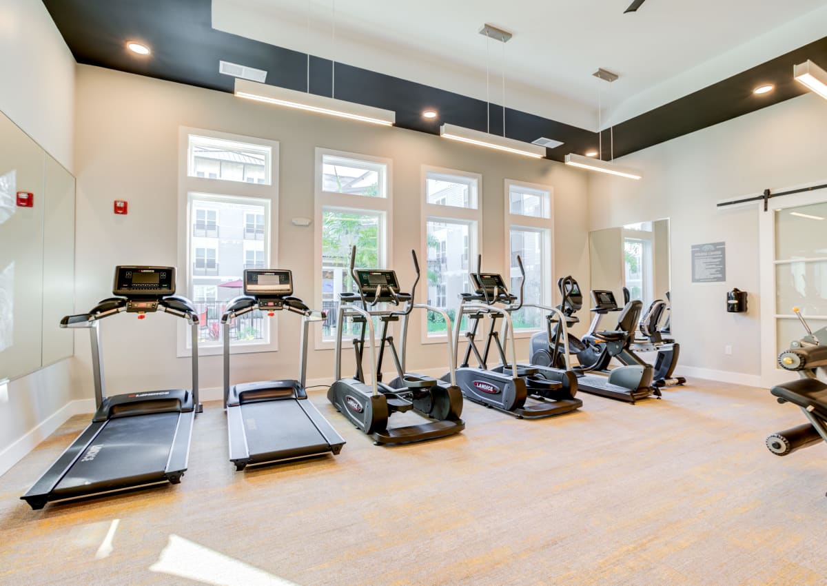 Man working out in the fitness center at The Pointe at Siena Ridge in Davenport, Florida
