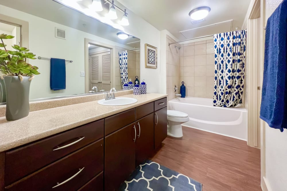 A mirrored closet door in a bathroom at Broadstone Grand Avenue in Pflugerville, Texas