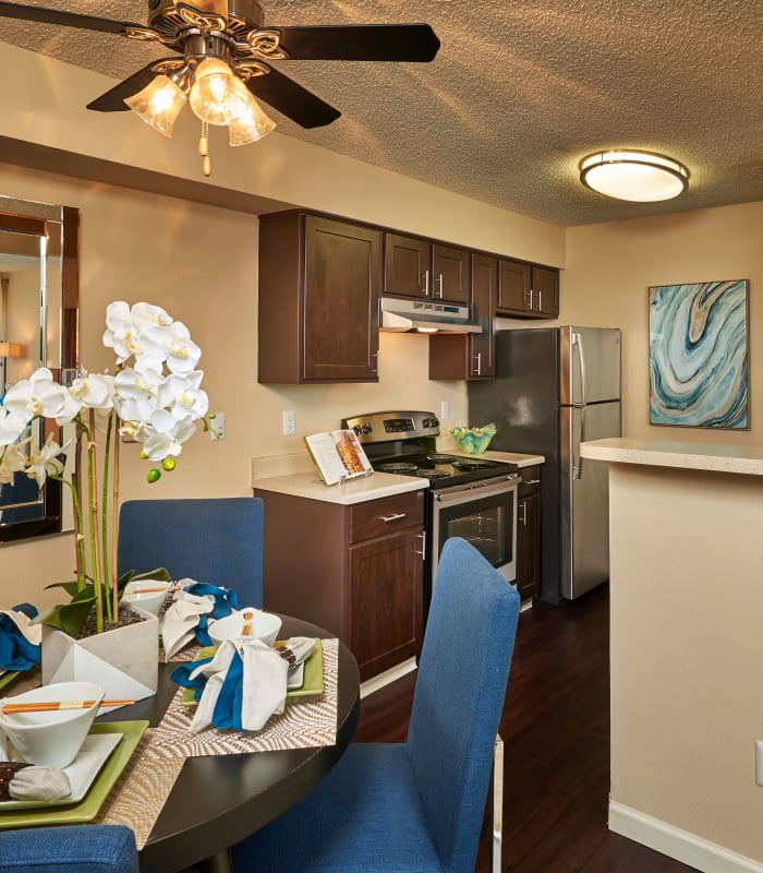 brown kitchen and dining room, model unit at Alton Green Apartments in Denver, CO