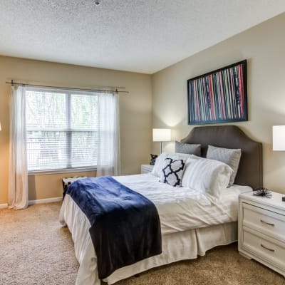 Bright bedroom with beige walls at Sofi Parc Grove in Stamford, Connecticut