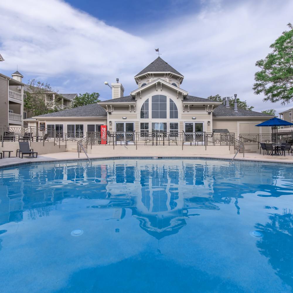 Swimming pool with view of clubhouse at One Belmar Place in Lakewood, Colorado
