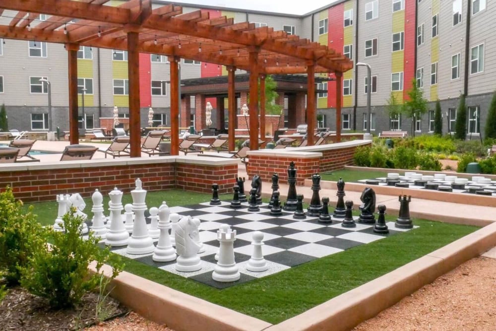 Community chessboard area under a cabana at Terra at University North Park in Norman, Oklahoma