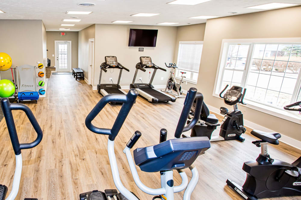 A fitness center with lots of natural lighting at Silver Lake Hills in Fenton, Michigan