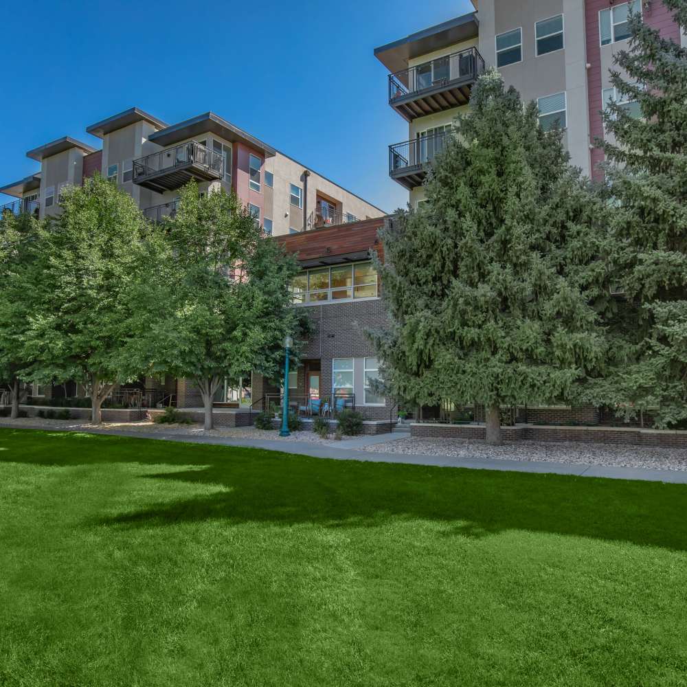 Exterior view of the community with green lawn at Park Place Olde Town Apartments in Arvada, Colorado