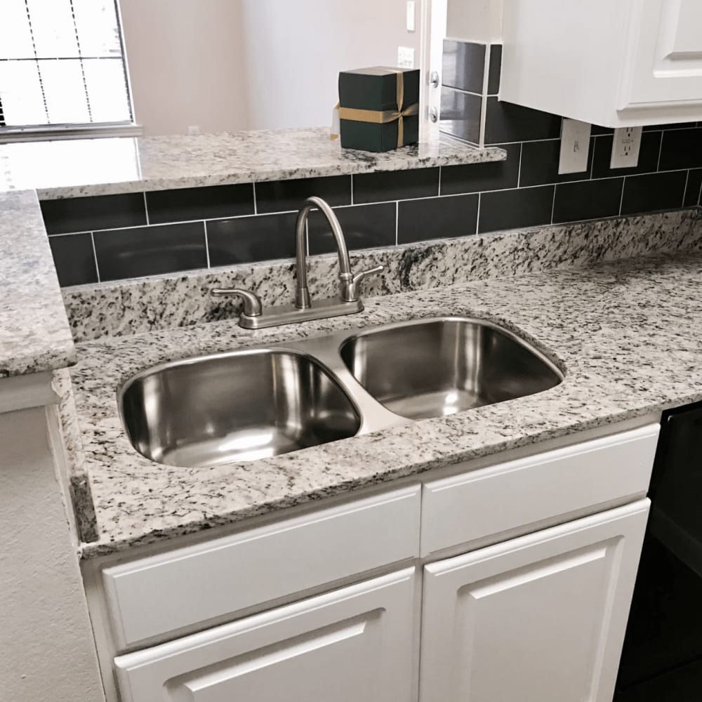 Stainless steel sink in a kitchen of an apartment at Dominion Park in San Antonio, Texas