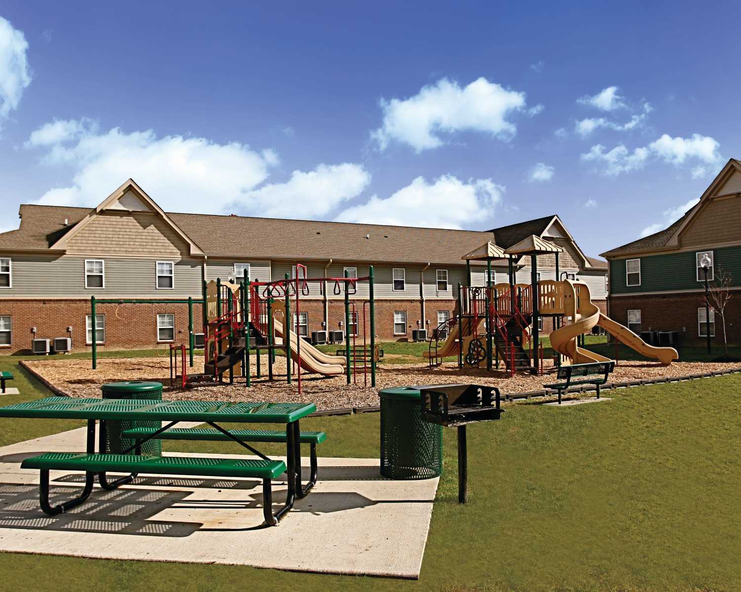 Community apartment with green lawn at Whispering Woods in Louisville, Kentucky