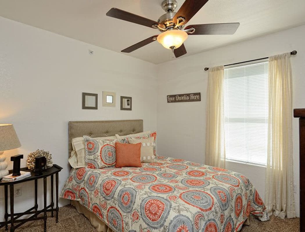 Bedroom with a ceiling fan at The Patriot Apartments in El Paso, Texas