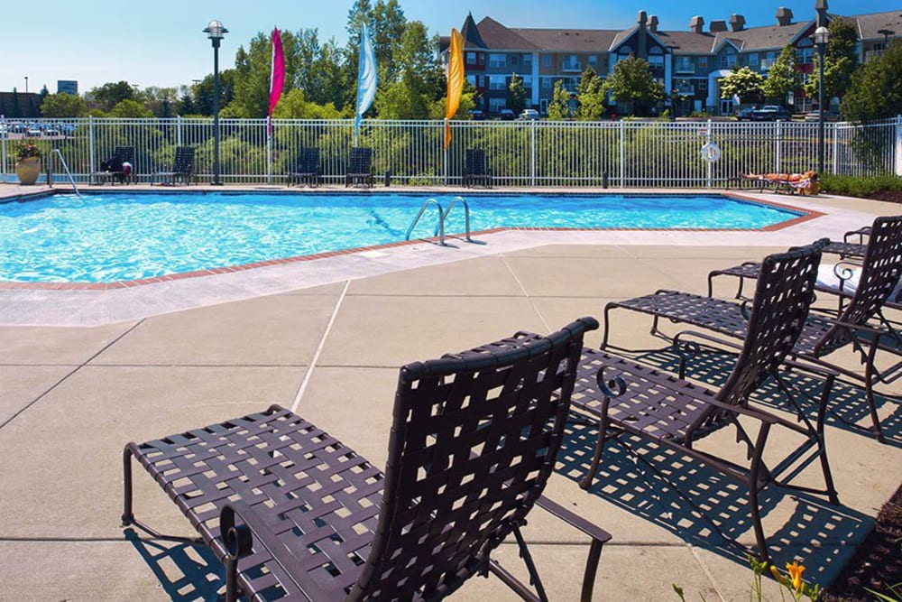 A swimming pool with patio seating at The Barrington in Woodbury, Minnesota