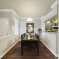 Modern furnishings in a model apartment's primary bedroom at River Pointe in Conroe, Texas