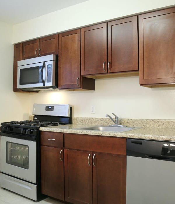 Wood style cabinets in the kitchen with tons of space on counters for cooking and baking at Eagle Rock Apartments at North Plainfield in North Plainfield, New Jersey