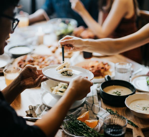 A group of friends sharing food near The Station at Clift Farm in Madison, Alabama