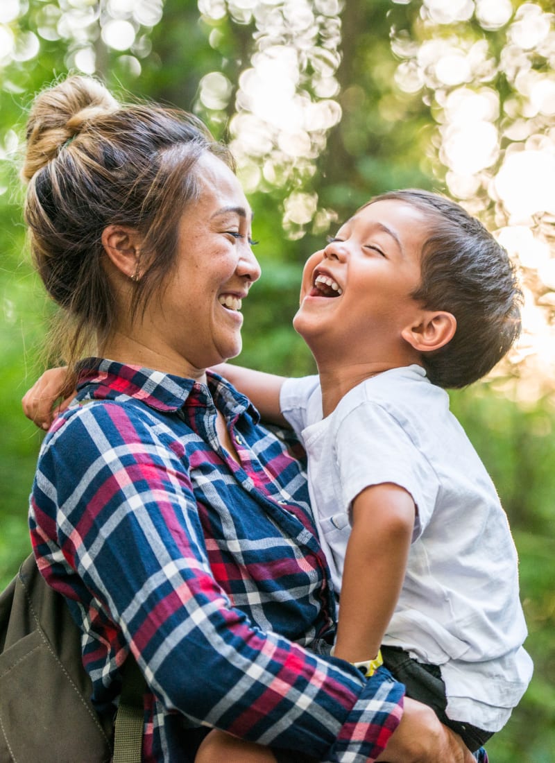 Resident laughing with her child near Marquis at Westchase in Houston, Texas