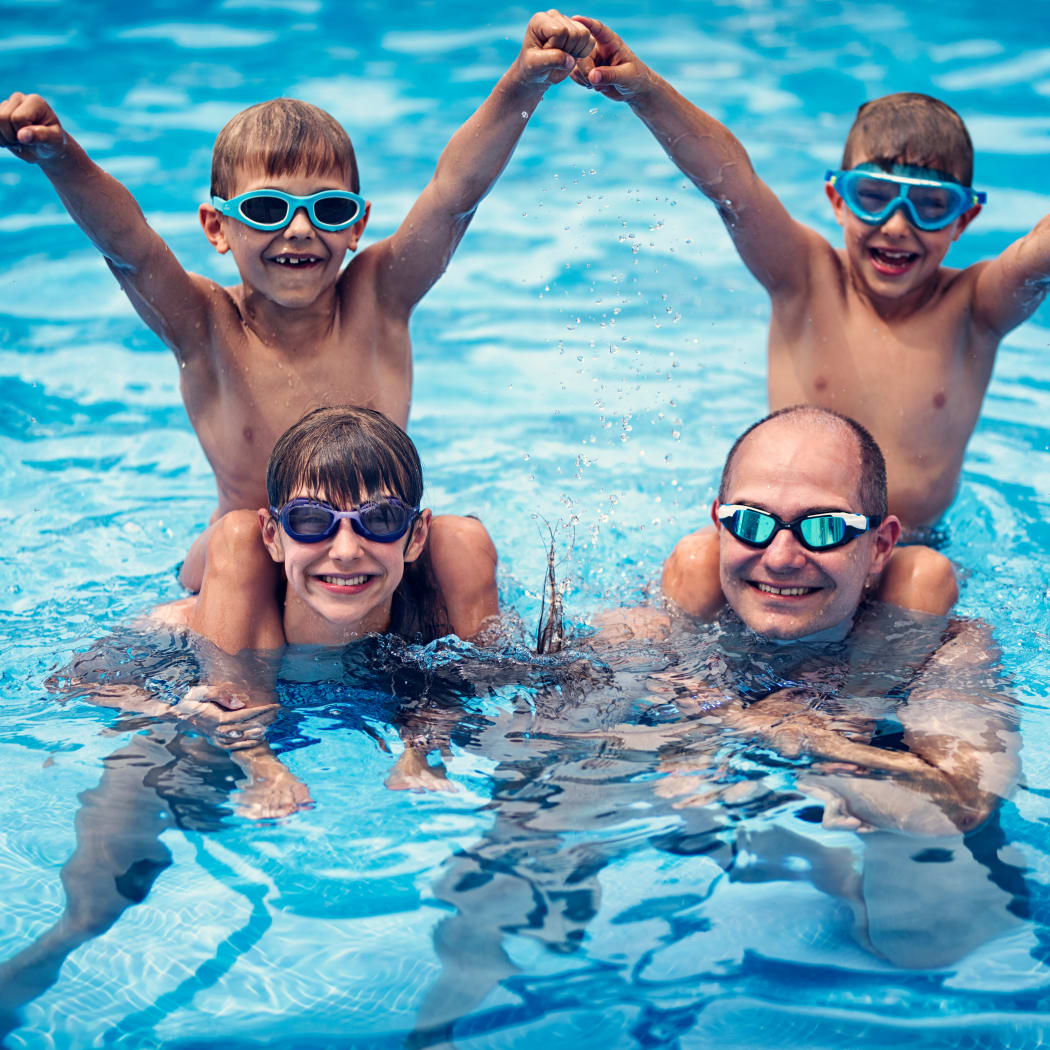 Family enjoying the refreshing swimming pool at Avilla Grace in Chandler, Arizona