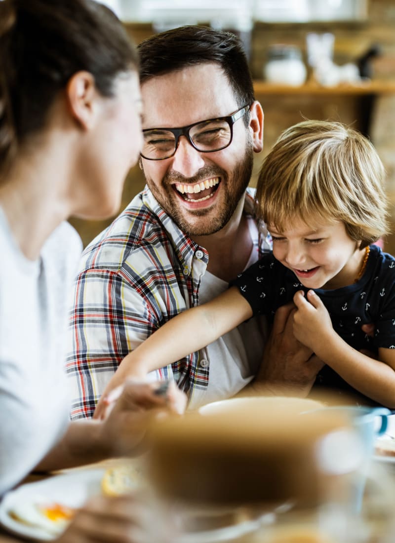 Residents laughing and playing with their son The Fairmont at Willow Creek in Folsom, California