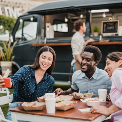 Residents taking a selfie at a food cart near Allina La Jolla in San Diego, California