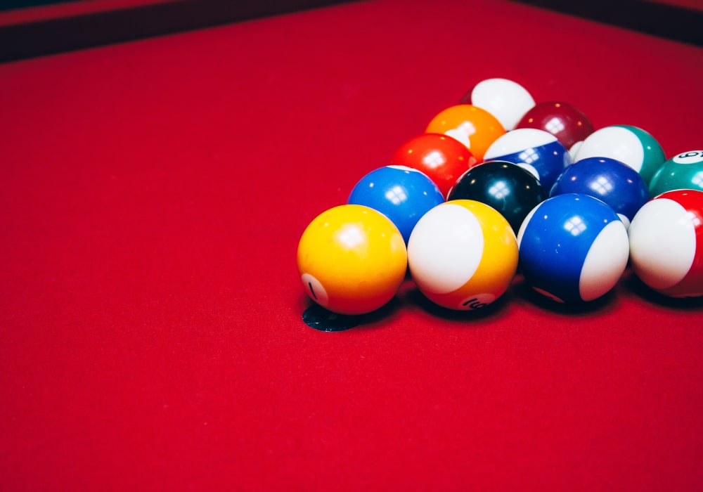 Close-up of billiards balls racked on red felt pool table at City View Lofts in Richmond, Virginia