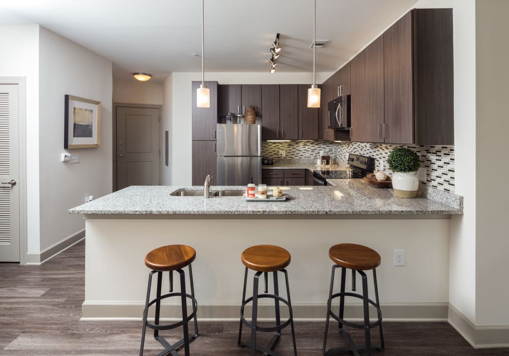 Enjoy a modern kitchen with breakfast bar at Axis Berewick in Charlotte, North Carolina