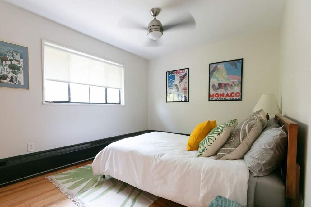 Bedroom with ceiling fan at Detroit Living in Detroit, Michigan