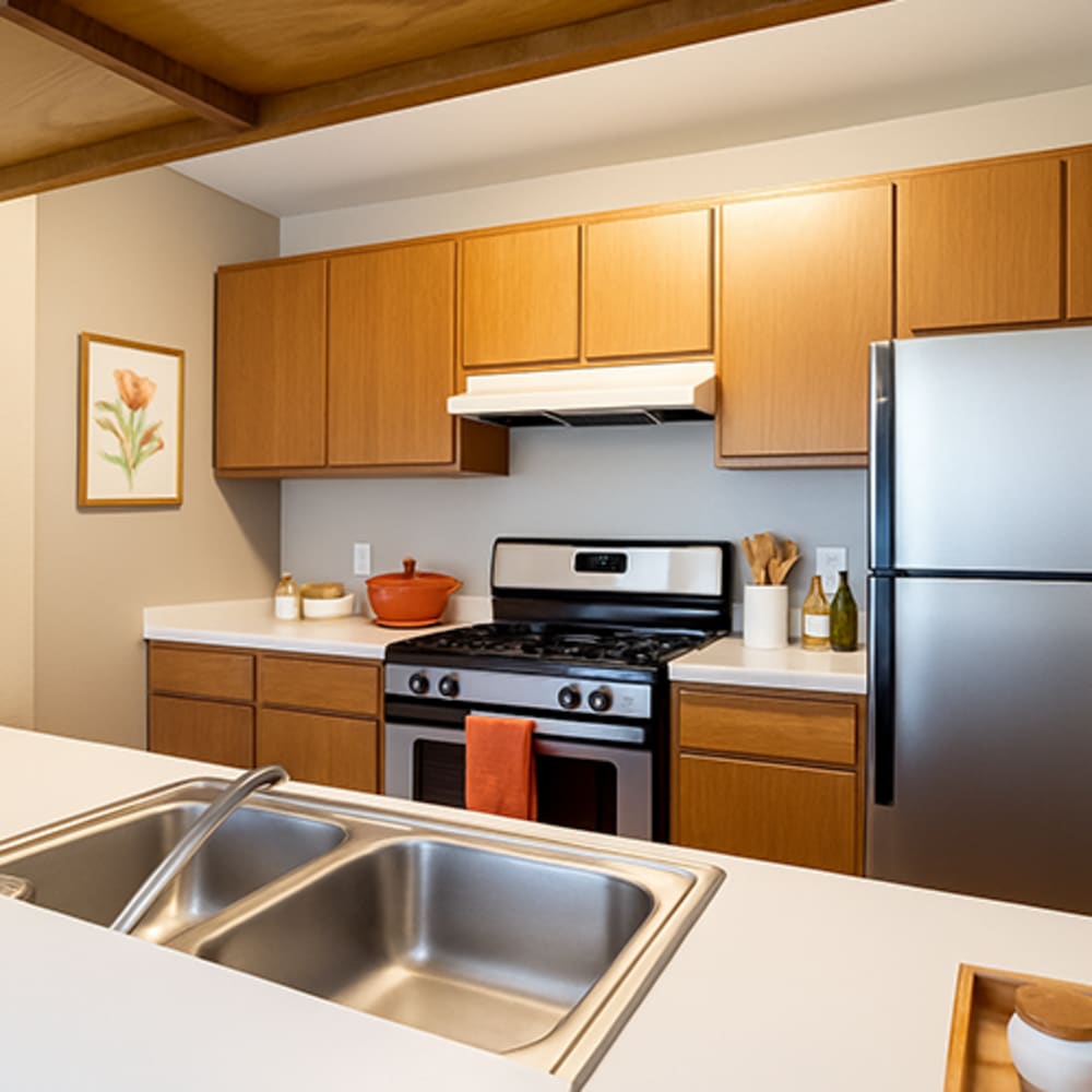 Kitchen with wooden cabinets at Central Park Place in Grand Rapids, Michigan