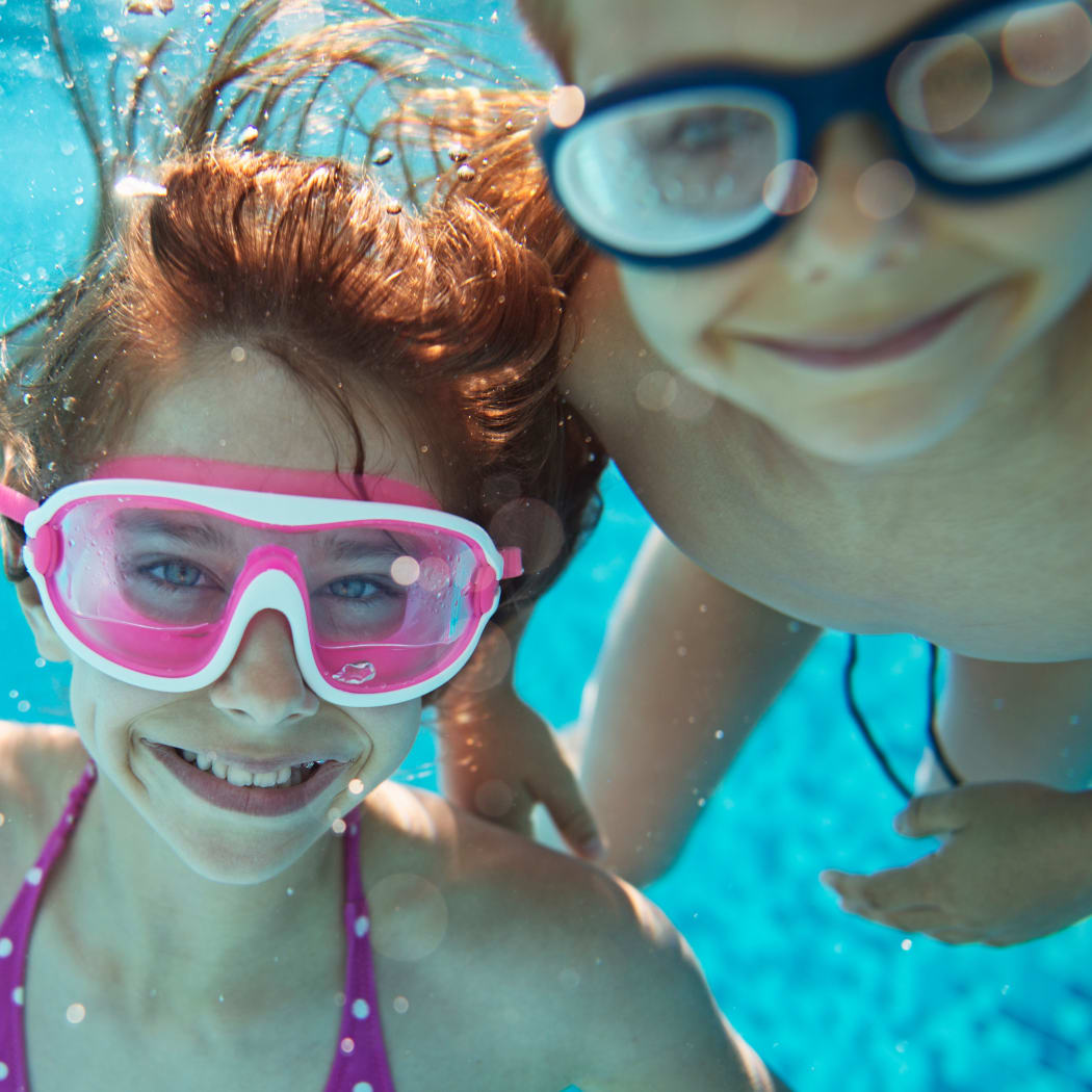 Kids enjoying the refreshing swimming pool at Avilla Northside in McKinney, Texas