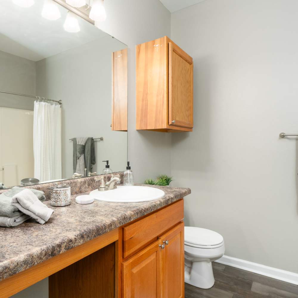 Bathroom with large mirror at Prairie Point Luxury Apartments in O'Fallon. MO