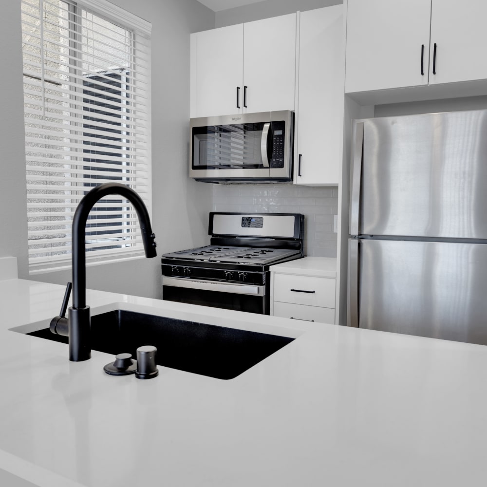 Modern kitchen with stainless-steel appliances at The Tower at Hollywood Hills, Los Angeles, California