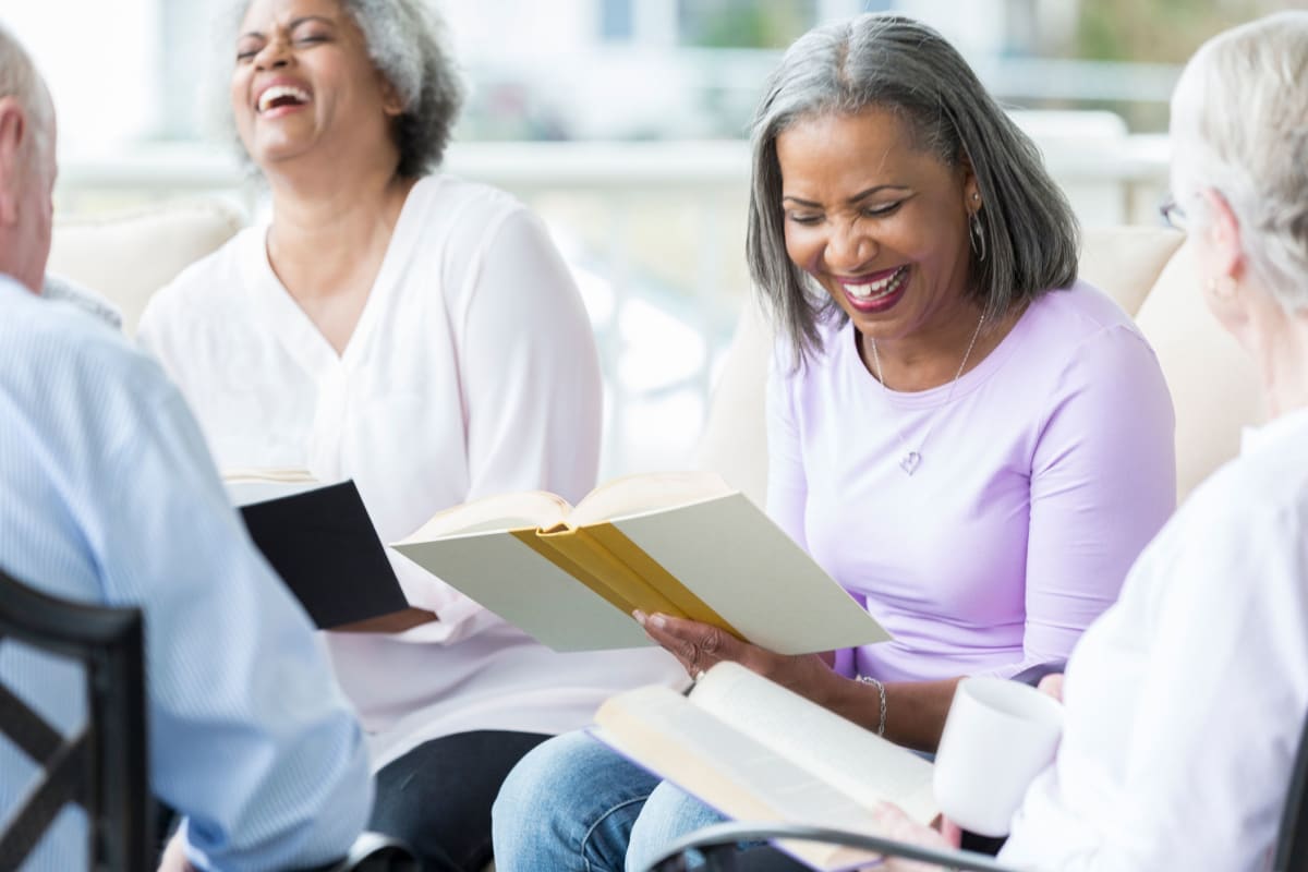 Smiling ladies book club at Oxford Villa Active Senior Apartments in Wichita, Kansas