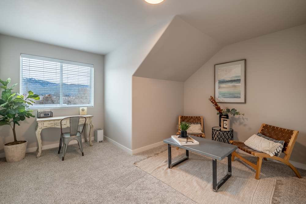 Bedroom area with studyt table and seating at 14th Street Townhomes in East Wenatchee, Washington