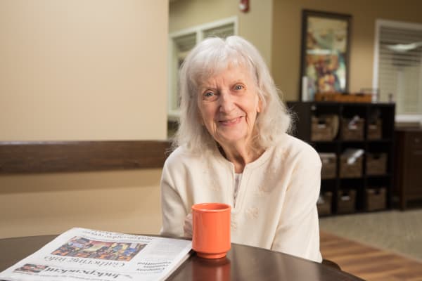 A resident reading the newspaper at The Heritage at Fountain Point in Norfolk, Nebraska