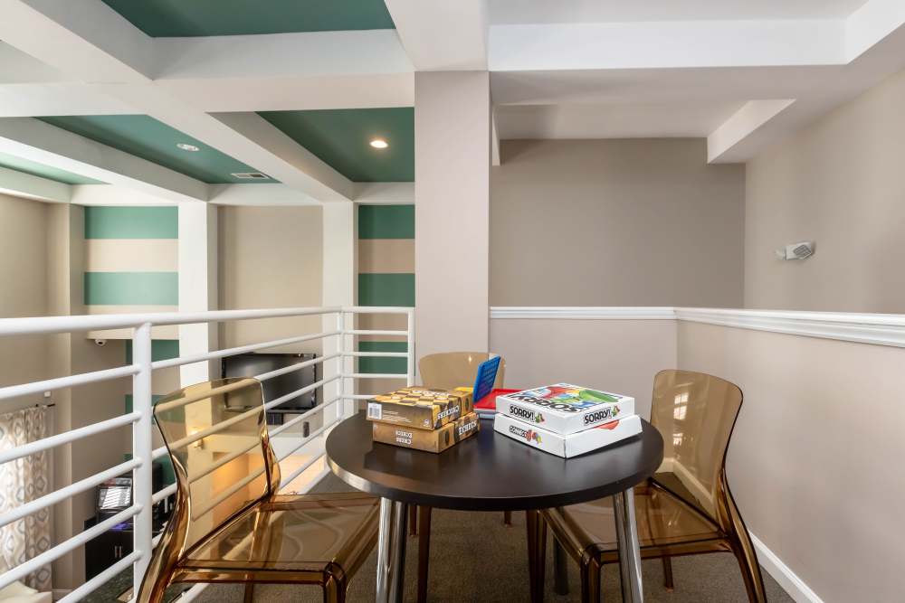 Community loft seating area with chairs and table at Camellia in Raleigh, North Carolina