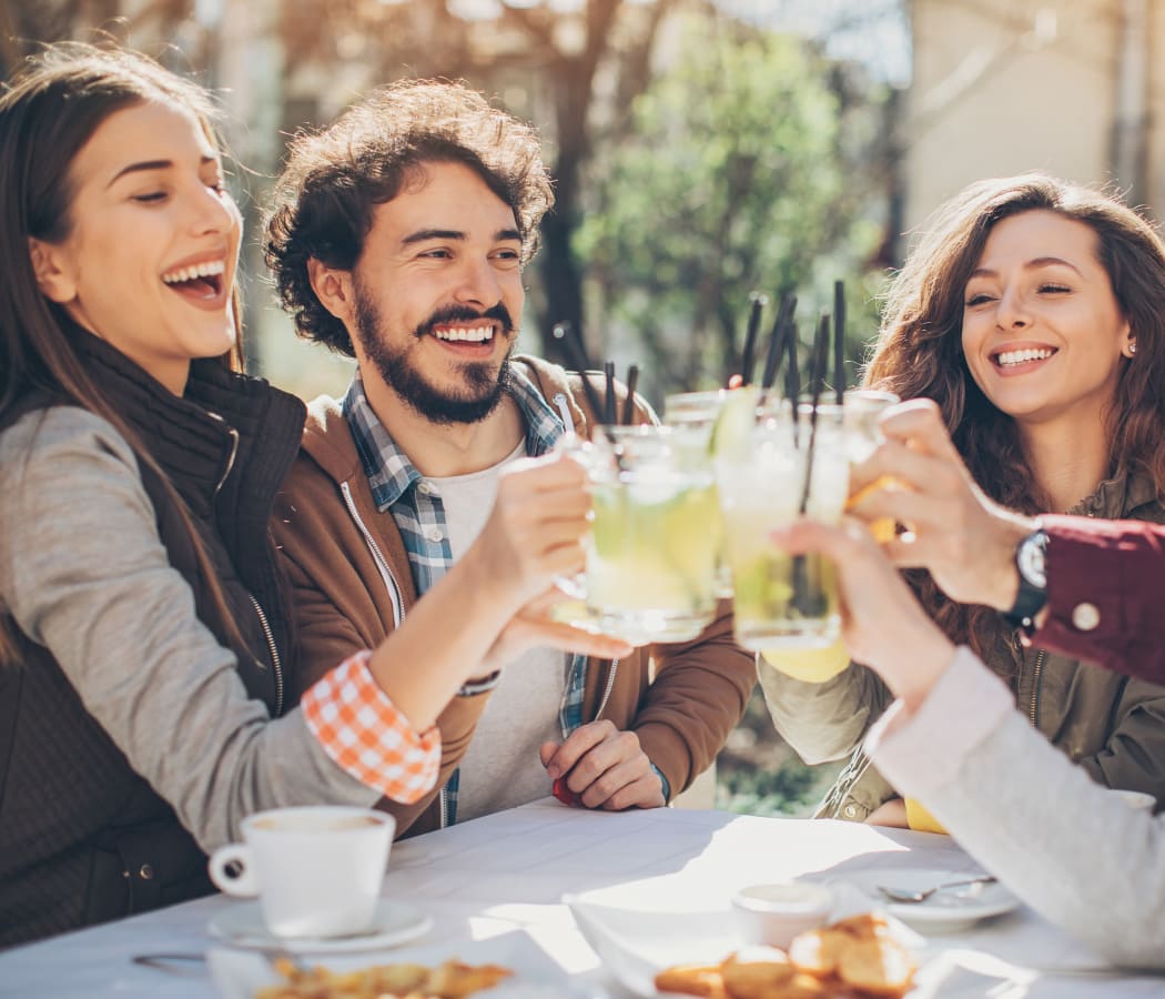 Friends having drinks together near Burbank Apartments in Boston, Massachusetts