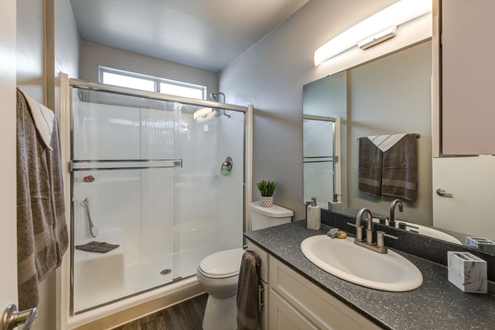 White cabinets in a renovated bathroom at Kendallwood Apartments in Whittier, California