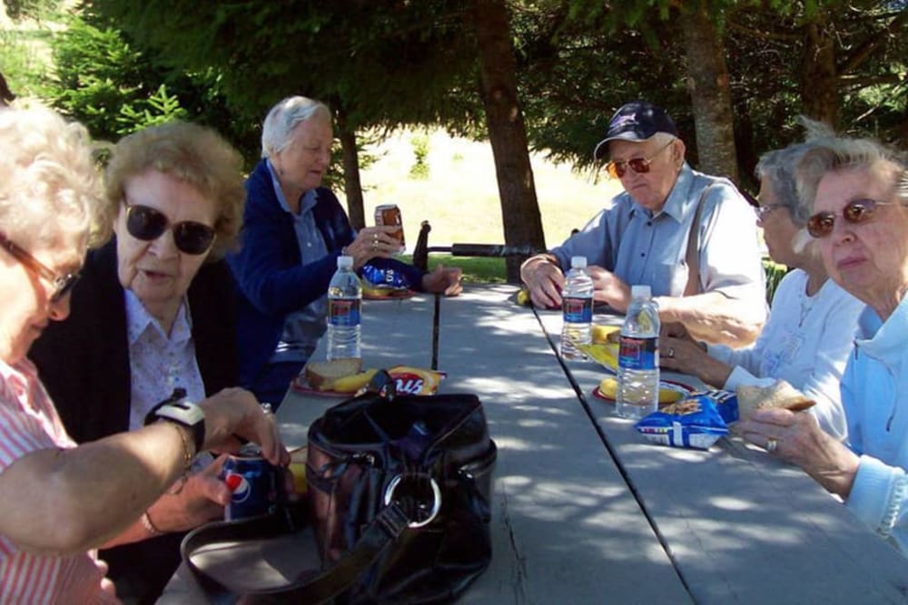 A group of residents sitting outside at Bayberry Commons in Springfield, Oregon