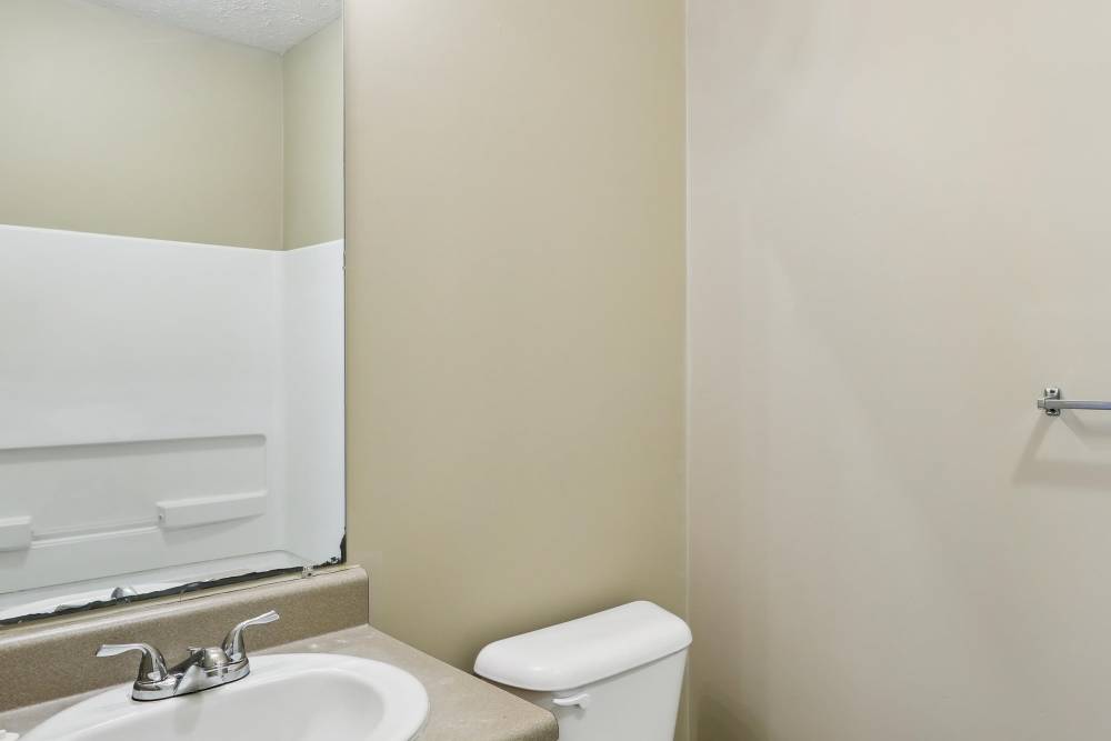 Bathroom with mirror, sink and commode at Camden Park in Canton, Mississippi