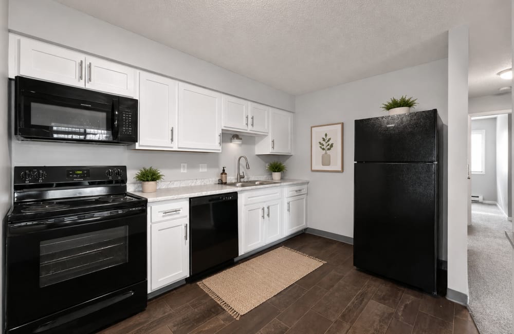 Kitchen with wooden flooring at Eastwood on Grand in West Des Moines, Iowa
