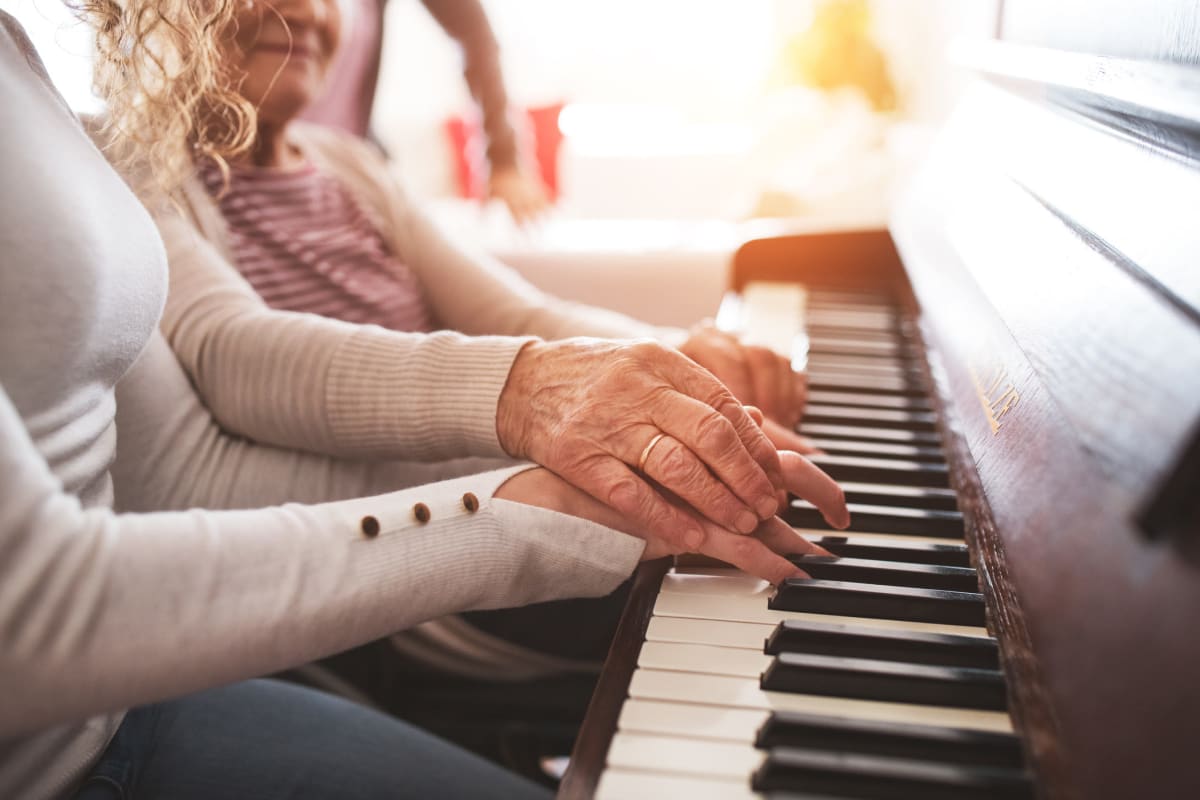 A resident playing the piano at The Oxford Grand Assisted Living & Memory Care in Kansas City, Missouri