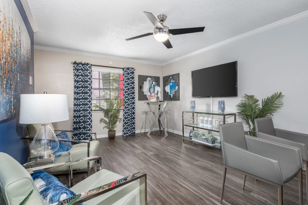 Large spacious living room with seating and large television at Barrington Place at Winter Haven in Winter Haven, Florida