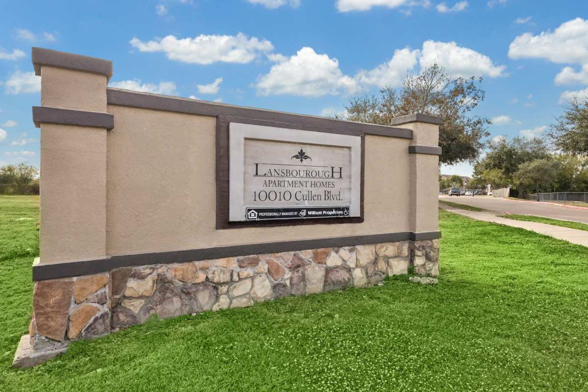 Entrance of apartments with property signage board at Lansbourough in Houston, Texas