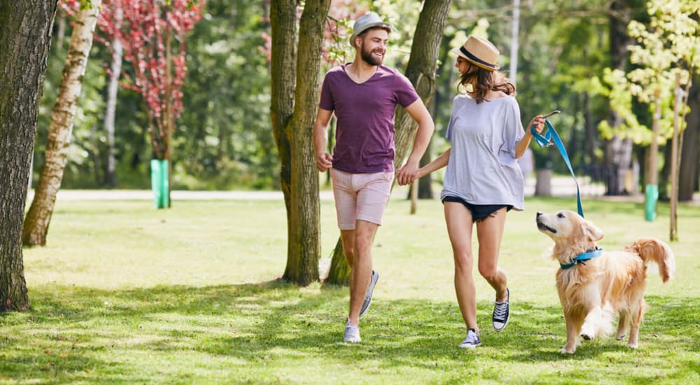 Couple jogging with their golden retriever at Bellrock La Frontera in Austin, Texas