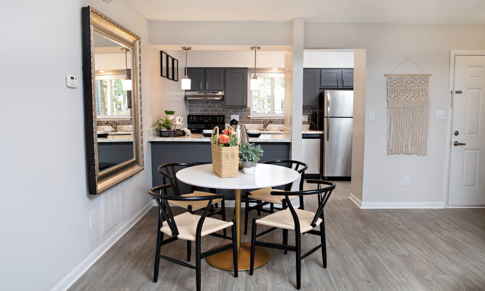 A dining table and chairs in a model apartment at Dwell at Carmel in Charlotte, North Carolina