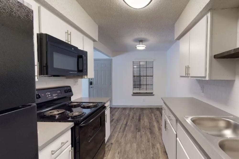 Fully-equipped apartment kitchen at The Haylie in Garland, Texas